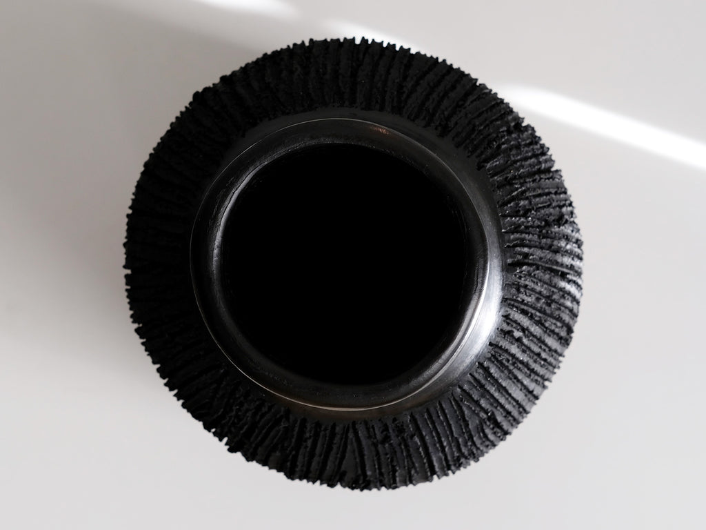 Black earthenware vase seen from above