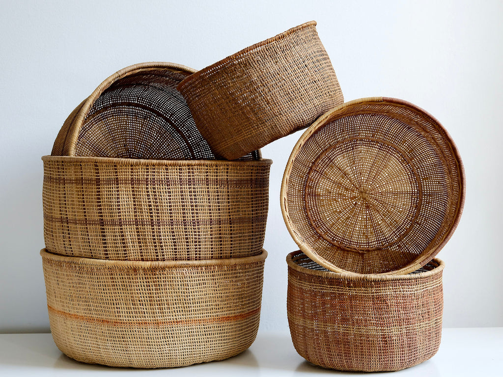 Stack of woven baskets on a white background