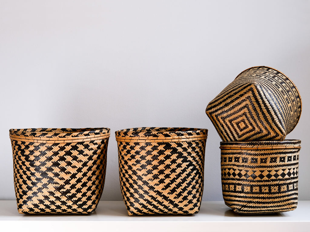 Set of woven baskets with geometric patterns on a light background