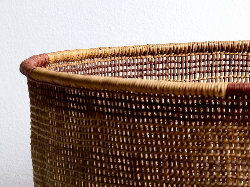 Close-up of a woven basket with a plain background