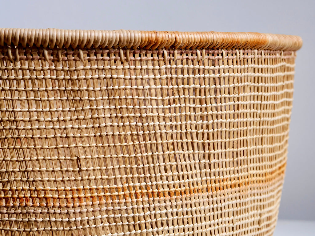 Close-up of a woven basket with a plain background